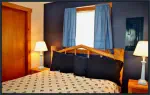 Rest well on a comfy queen bed in the Blue Duck Suite near Joseph, Oregon.