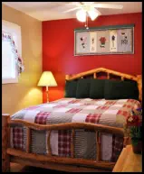 Enjoy a comfy queen bed and ceiling fan breezes in the Red Apple Room.