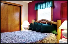 “Roost” in comfort on the log-style queen bed in the Red Rooster Suite