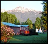 Views of lush lawn, tepees and mountains from the Red Rooster Suite private deck.
