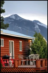 Stunning mountain views from the Americana Room back deck with patio furniture and BBQ grille.